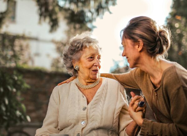 pexels-photo-3768131 joyful adult daughter greeting happy surprised senior mother in garden
